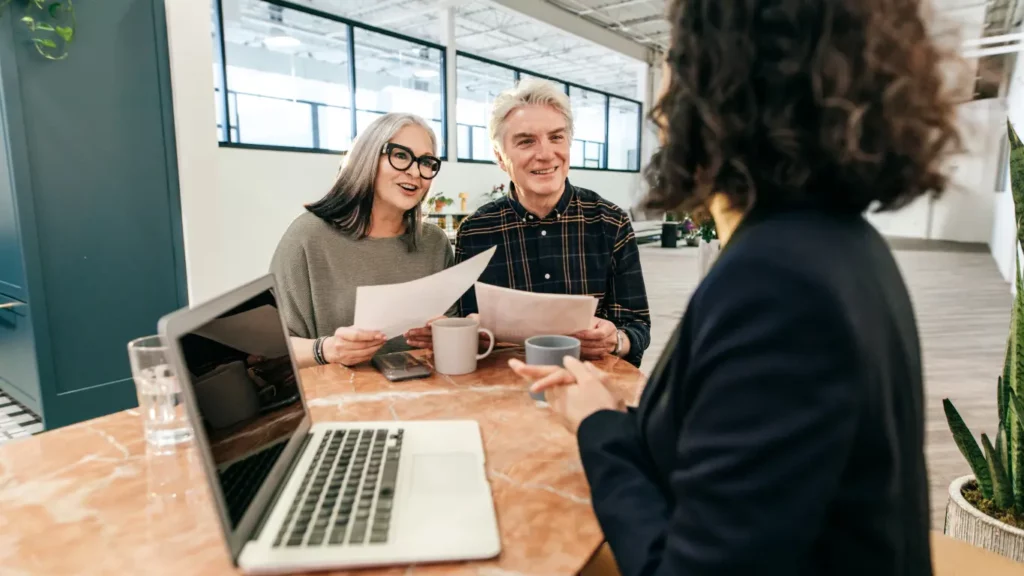 Two people holding business insurance papers