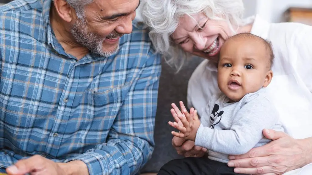 Grandparents holding grandchild