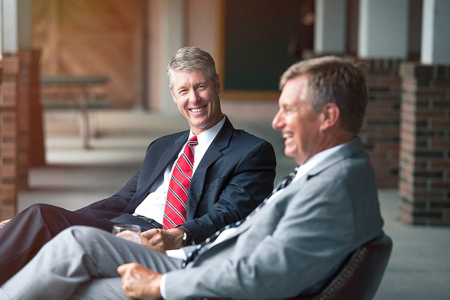 About Our Agency - Chad Bales And Gary Nichols Sitting In Chairs Chatting