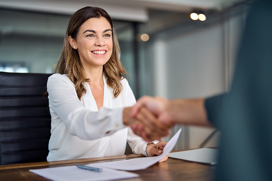 Mineral HR Solutions - Cheerful Office Worker Shaking Hands With a Coworker